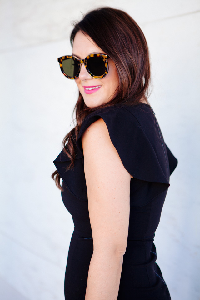 Kendi Everyday in Little Black Dress with Ruffle Sleeves.